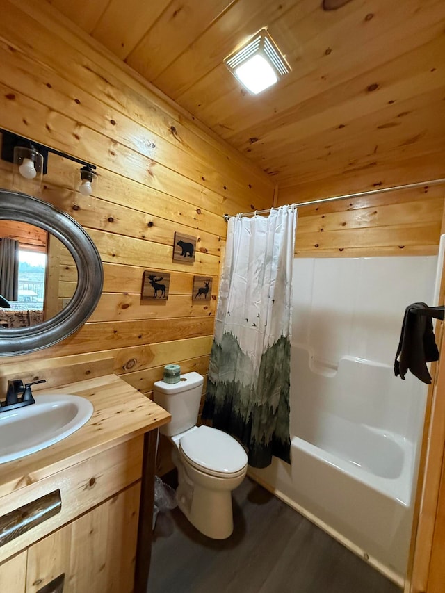 full bathroom with hardwood / wood-style floors, shower / bath combo, vanity, wooden ceiling, and toilet