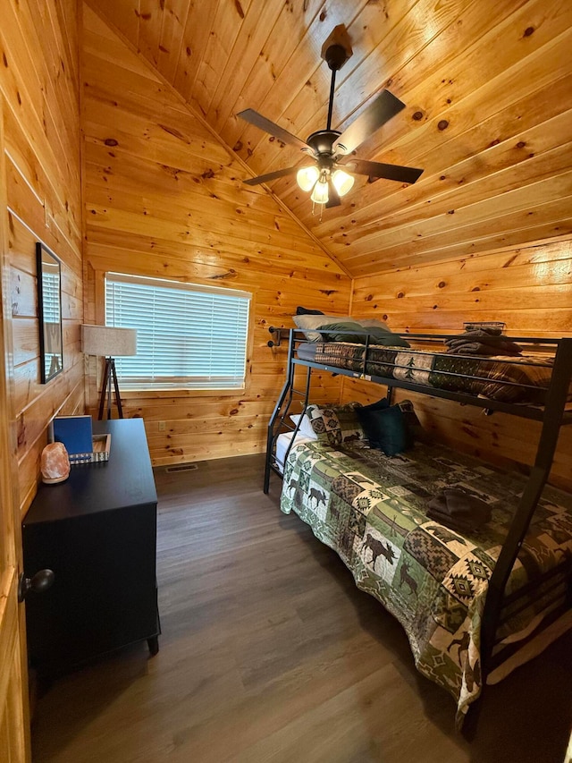 bedroom with wood walls, lofted ceiling, ceiling fan, dark hardwood / wood-style floors, and wood ceiling