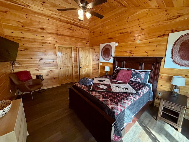 bedroom featuring wood ceiling, ceiling fan, wooden walls, dark hardwood / wood-style floors, and lofted ceiling