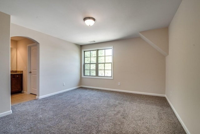 interior space with lofted ceiling and light colored carpet