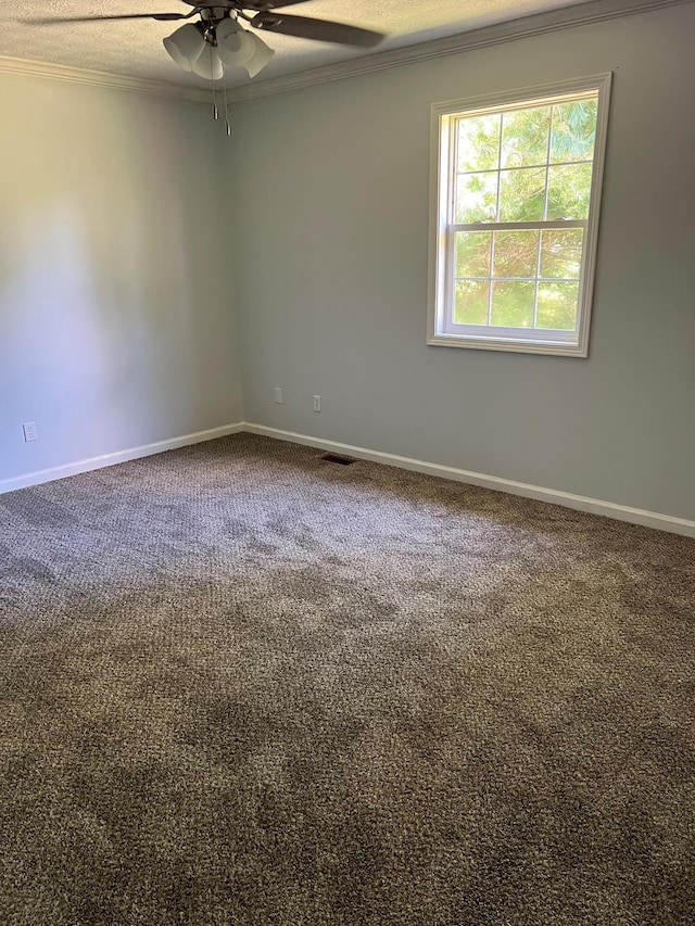 unfurnished room featuring baseboards, carpet flooring, visible vents, and crown molding