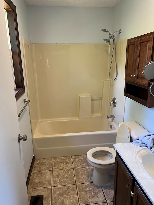 bathroom featuring visible vents, toilet, vanity,  shower combination, and tile patterned floors