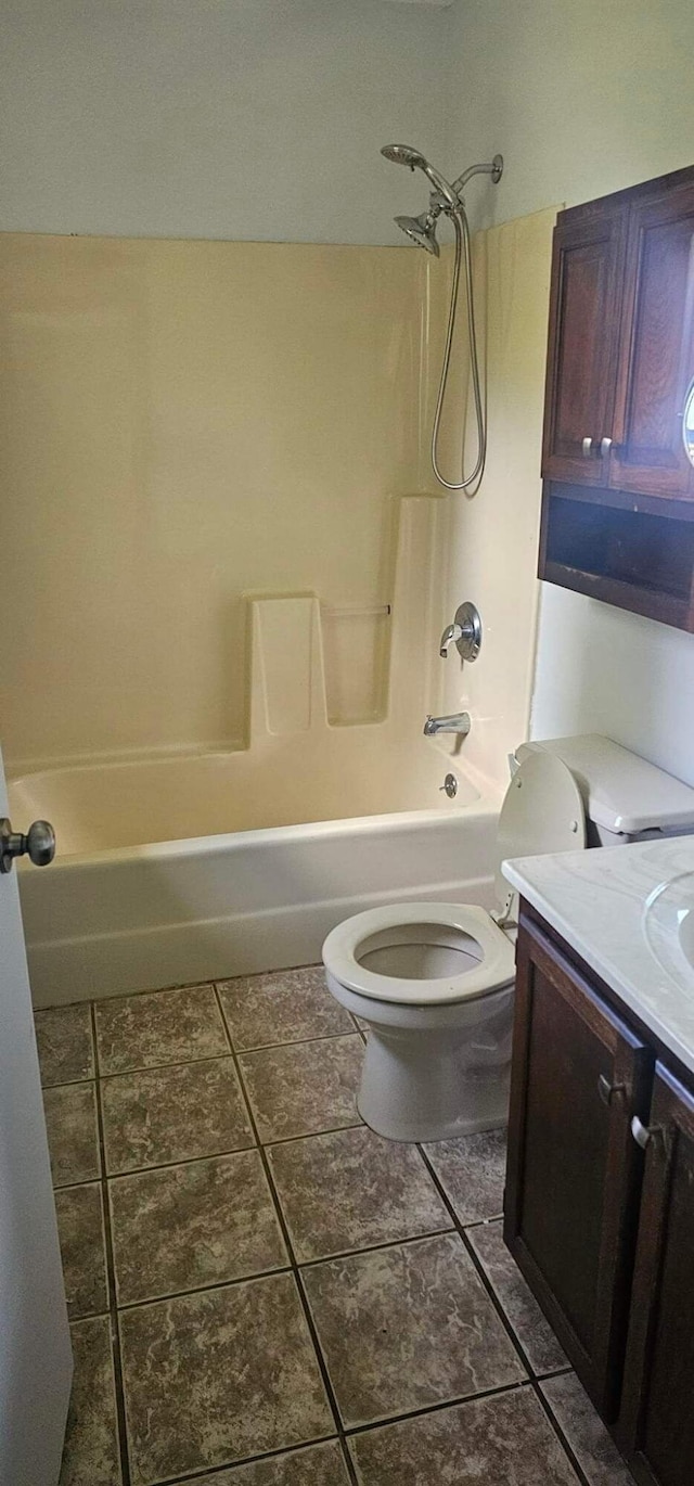 bathroom with tile patterned flooring, tub / shower combination, vanity, and toilet