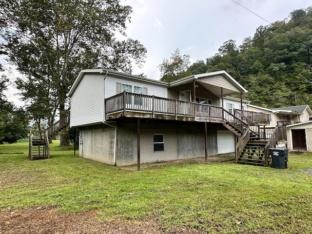 back of property with a lawn and a wooden deck