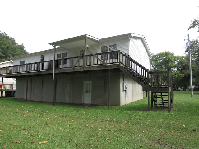 back of property with a wooden deck and a lawn