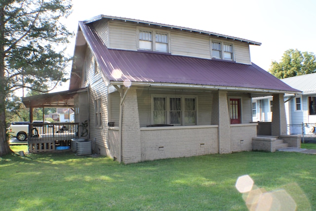 back of house featuring a lawn and central AC unit