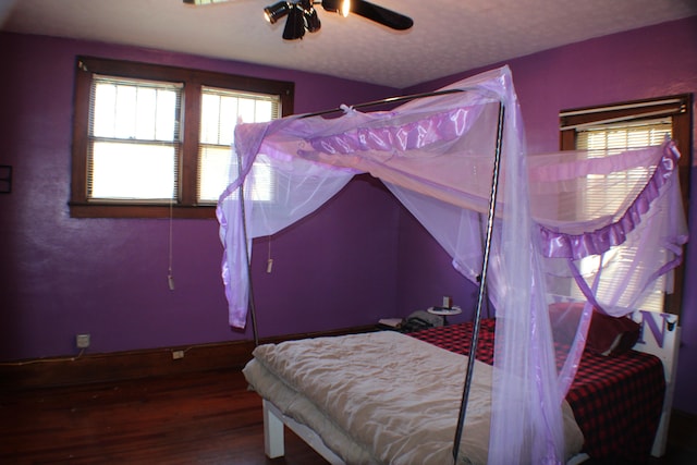 bedroom with ceiling fan and dark wood-type flooring