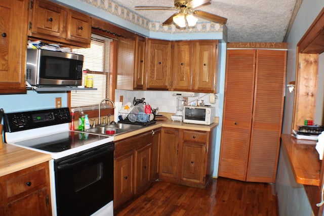 kitchen with dark hardwood / wood-style flooring, tasteful backsplash, ceiling fan, white appliances, and sink