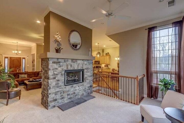 living room featuring carpet floors, ceiling fan with notable chandelier, ornamental molding, and a fireplace