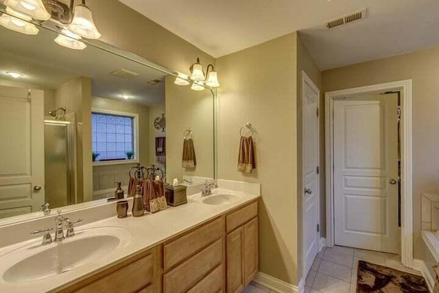 bathroom featuring tile patterned flooring, double vanity, and an inviting chandelier