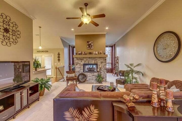 living room with a fireplace, plenty of natural light, ceiling fan, and light colored carpet