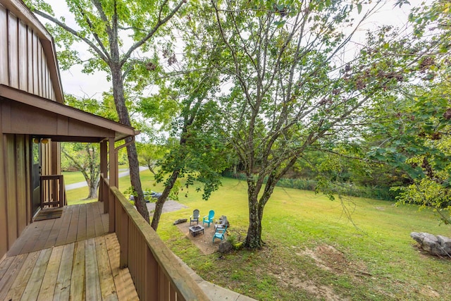 wooden terrace featuring a lawn