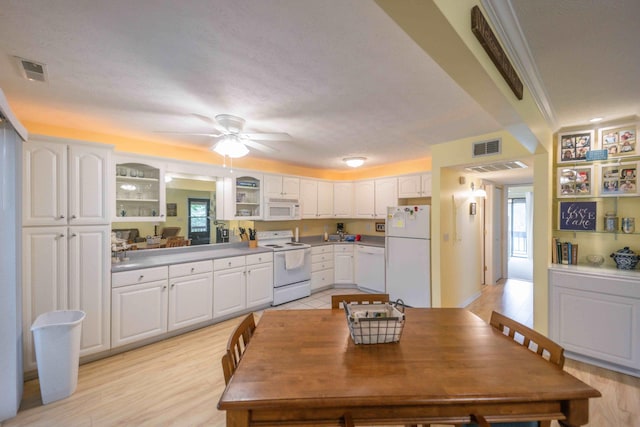 kitchen with white cabinets, light hardwood / wood-style flooring, ceiling fan, and white appliances