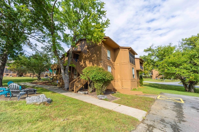 view of side of home with a yard