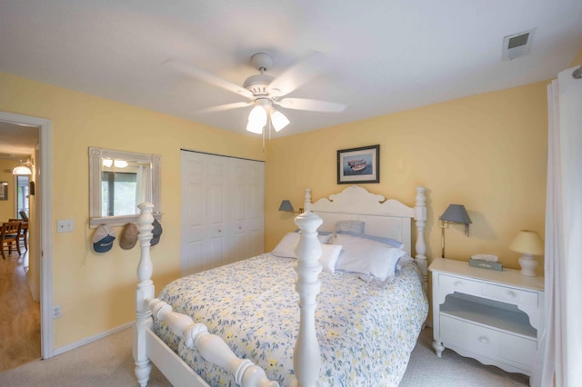 carpeted bedroom featuring a closet and ceiling fan