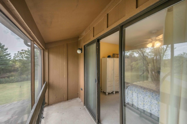 unfurnished sunroom featuring ceiling fan