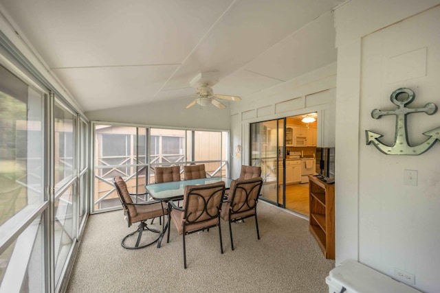 sunroom with ceiling fan and lofted ceiling