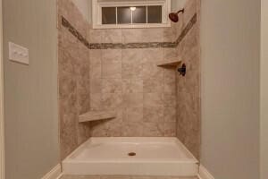 bathroom with tiled shower