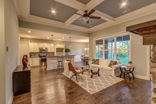 living room with dark hardwood / wood-style floors, ceiling fan, ornamental molding, coffered ceiling, and beam ceiling