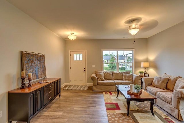 living room featuring light wood-style flooring and baseboards