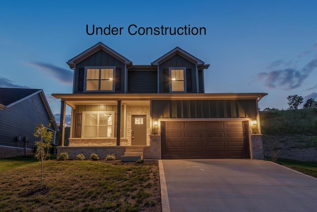 view of front of house featuring board and batten siding, concrete driveway, a porch, and an attached garage