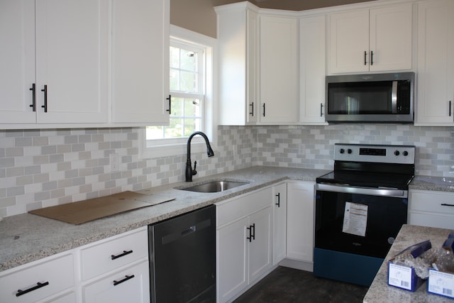 kitchen featuring appliances with stainless steel finishes, tasteful backsplash, sink, and white cabinets