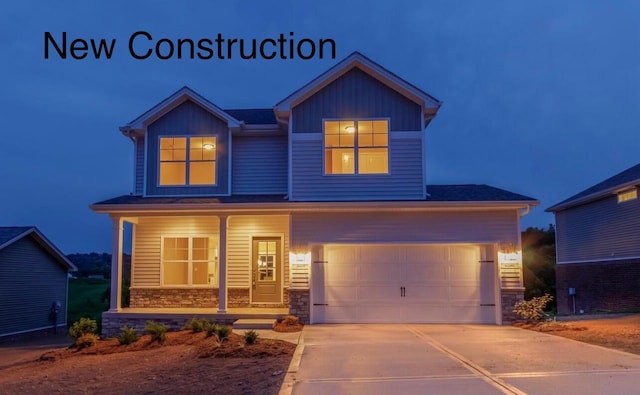 view of front of property featuring stone siding, board and batten siding, covered porch, concrete driveway, and a garage