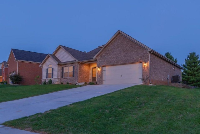 view of front of house featuring a garage and a yard