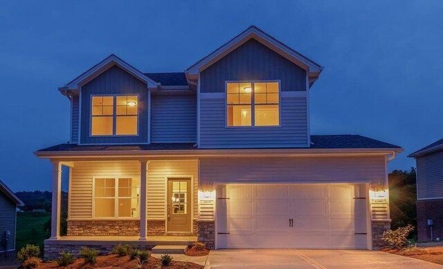 view of front of property featuring a porch, central air condition unit, and a garage