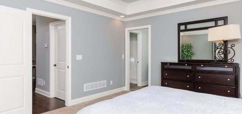 carpeted bedroom with crown molding