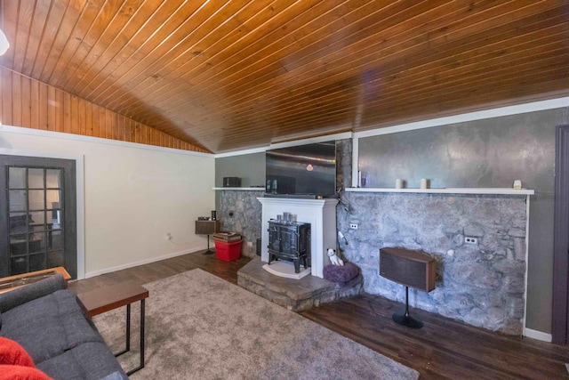 living room with wood ceiling, dark wood-type flooring, a wood stove, and a fireplace