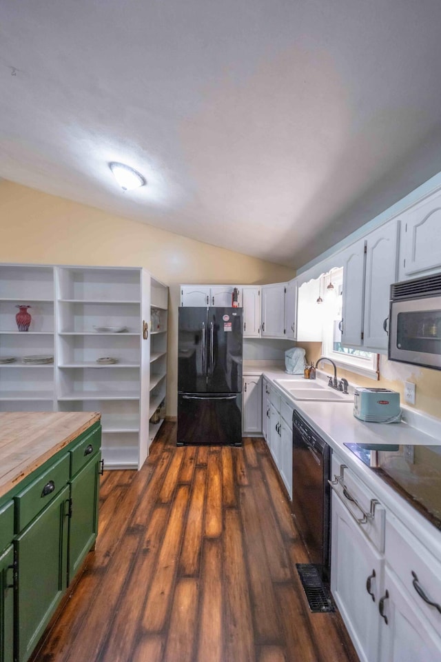 kitchen featuring dark wood-type flooring, white cabinets, black appliances, sink, and vaulted ceiling