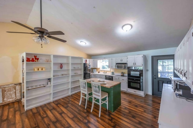 kitchen featuring ceiling fan, vaulted ceiling, black appliances, and a healthy amount of sunlight