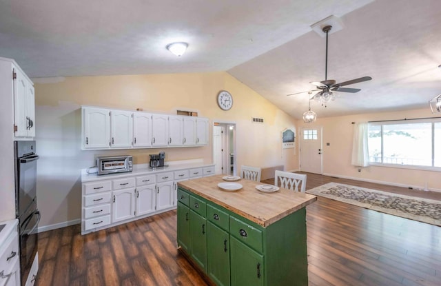 kitchen featuring green cabinetry, white cabinetry, dark hardwood / wood-style floors, ceiling fan, and vaulted ceiling