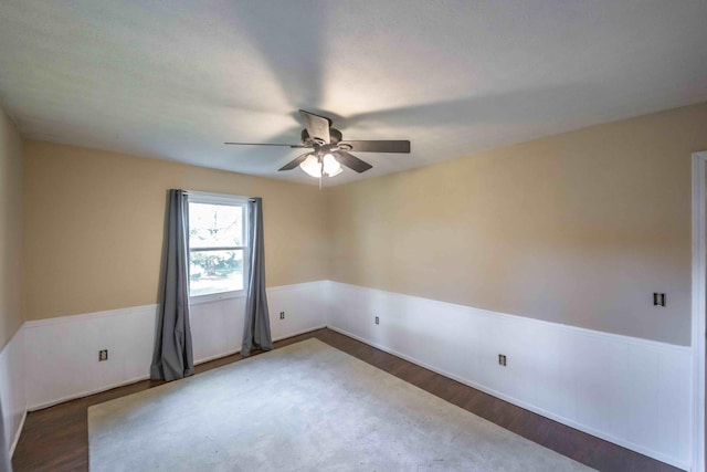 unfurnished room featuring ceiling fan and dark hardwood / wood-style floors