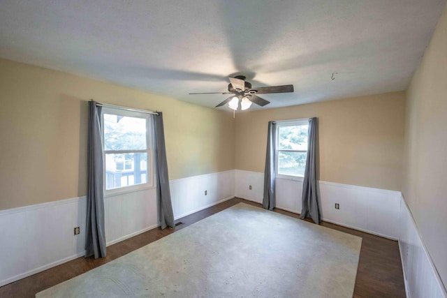 spare room featuring ceiling fan and dark hardwood / wood-style floors