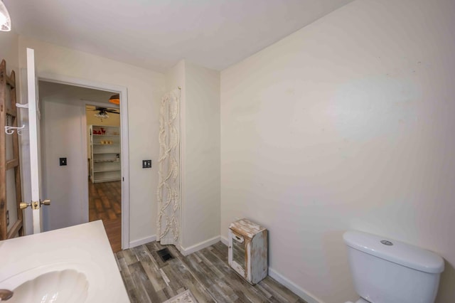 bathroom featuring toilet, vanity, ceiling fan, and hardwood / wood-style floors