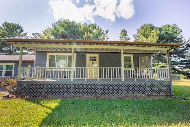 view of front of property with covered porch and a front yard