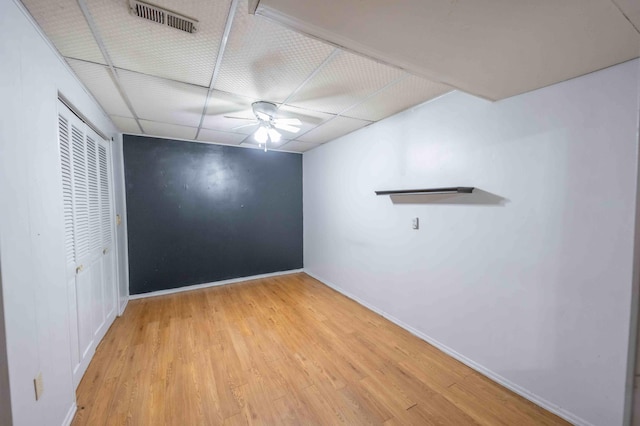 unfurnished room with ceiling fan, light wood-type flooring, and a paneled ceiling