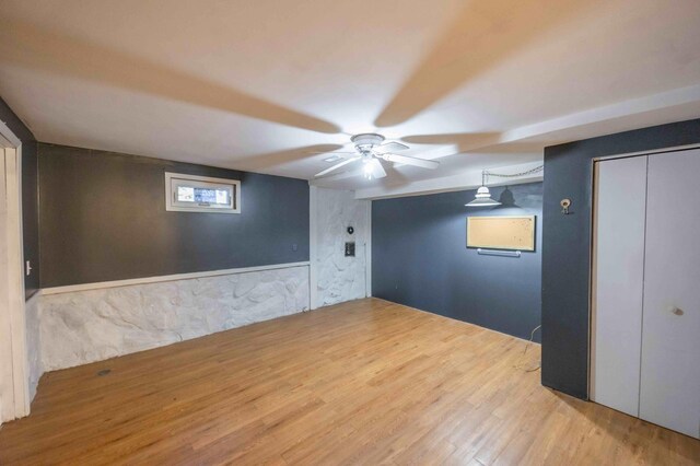 empty room with ceiling fan and light wood-type flooring