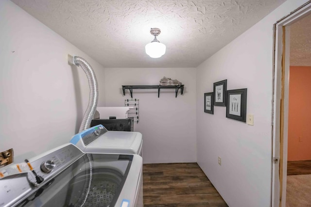 clothes washing area with a textured ceiling, dark hardwood / wood-style flooring, and independent washer and dryer