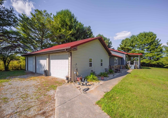 view of side of home featuring a yard and covered porch