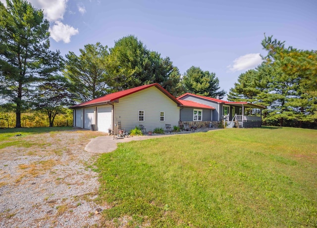 ranch-style house featuring a front yard and a garage