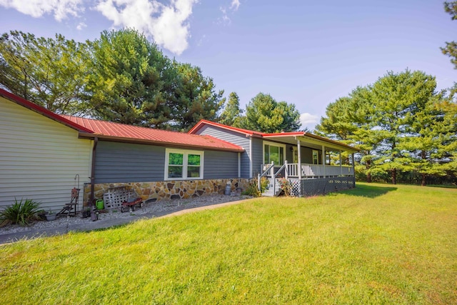 back of property featuring a lawn and a porch