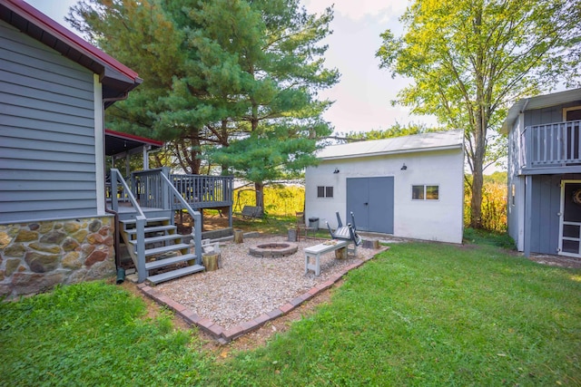 view of yard with a wooden deck and an outdoor fire pit