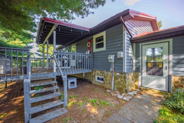 view of property exterior featuring a wooden deck