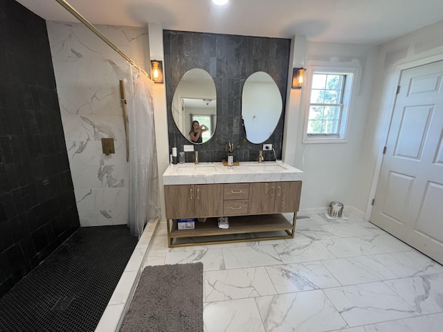 bathroom with a tile shower, vanity, and tile walls