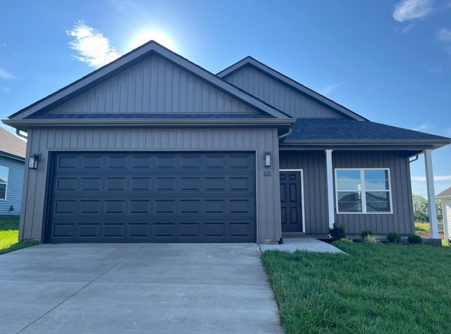 ranch-style house featuring a garage, board and batten siding, a front lawn, and concrete driveway