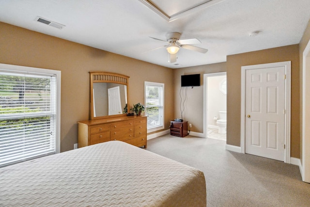 carpeted bedroom with ceiling fan and ensuite bathroom