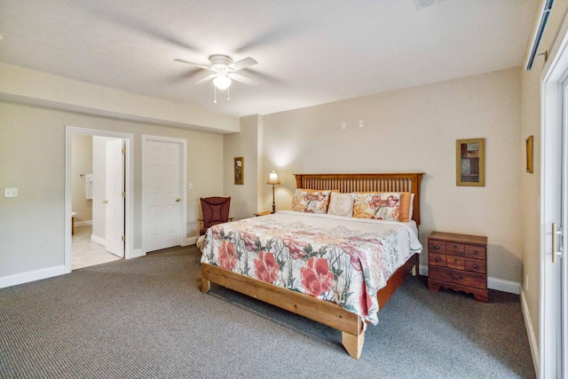 carpeted bedroom with ensuite bath and ceiling fan